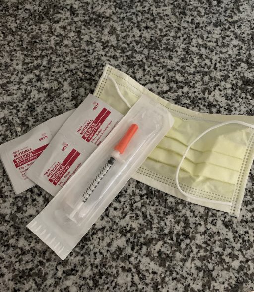 syringe and alcohol wipes and mask