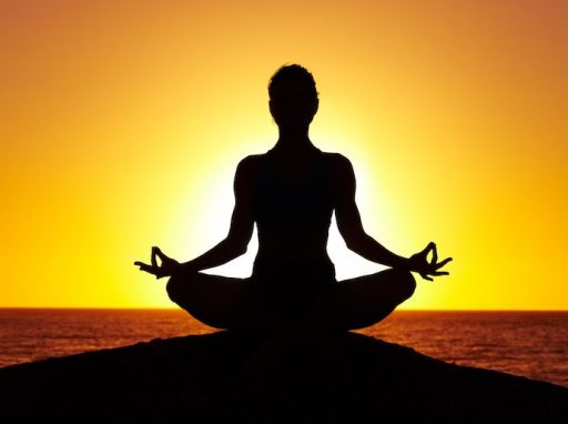 yogi sitting with sunset