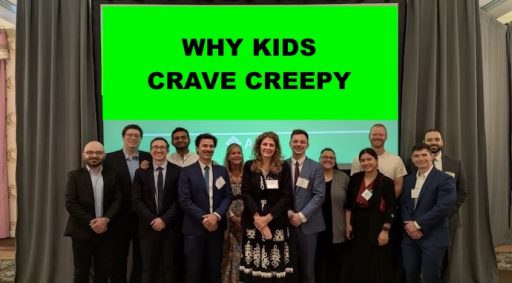 group of people under a white board that says why kids crave creepy